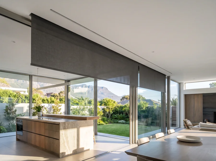 Roller blind concealed in a recessed ceiling slot above glazing in a Southern Suburbs kitchen extension